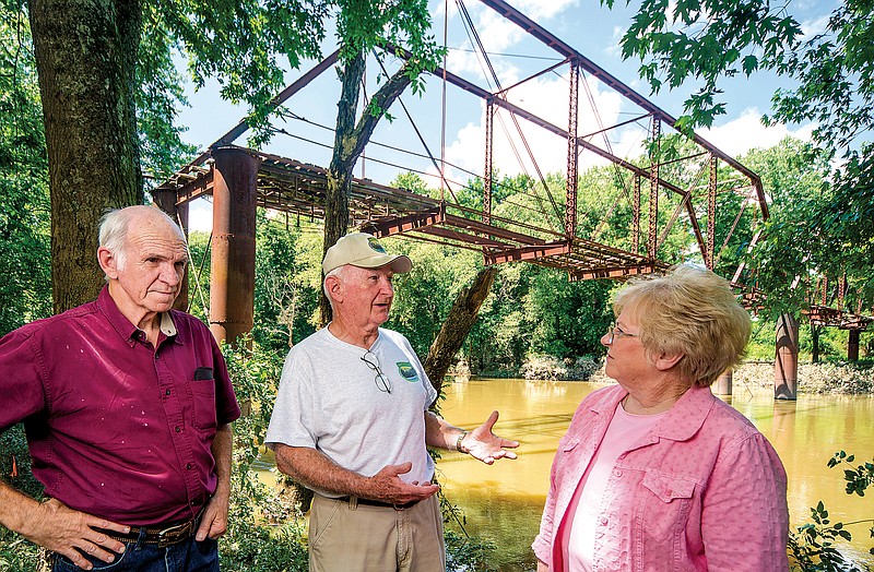 Doyle Ritchey, from left, Lynn Moore and Linda Keaton, all members of the Saline Crossing Regional Park and Recreation Area Inc., talk about plans for the bicentennial celebration of Saline Crossing in 2015 near the Iron Bridge in Benton.