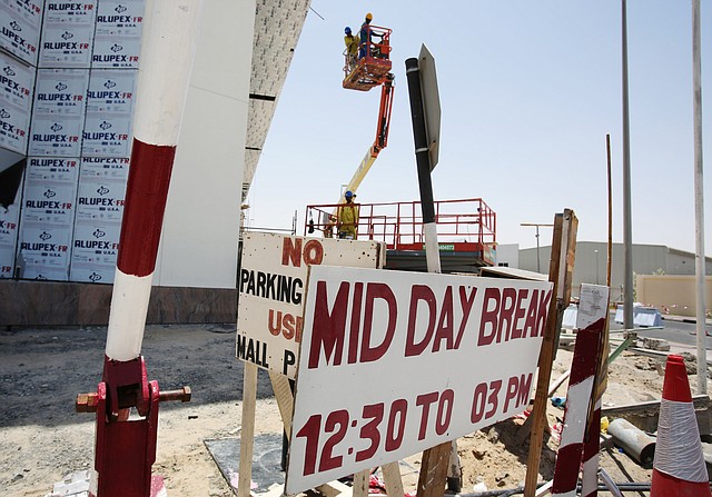 In this Sunday, June 15, 2014 photo, laborers descend in a lift as they start their midday break at the Dragon Mart Phase 2 construction site in Dubai, United Arab Emirates. A midday work ban goes into effect across the United Arab Emirates for construction workers and outdoor laborers, on Sunday, to protect them from the risks of direct sunlight and extremely high temperatures during the hottest summer months.