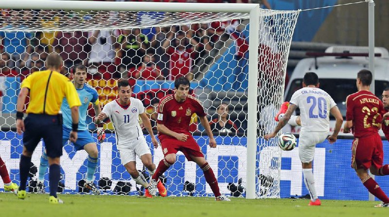 Chile’s Charles Aranguiz (20) shoots to score his team’s second goal in a 2-0 Group B victory Wednesday at Maracana Stadium in Rio de Janeiro. The loss eliminated Spain, the 2010 World Cup champion, from title contention this year.