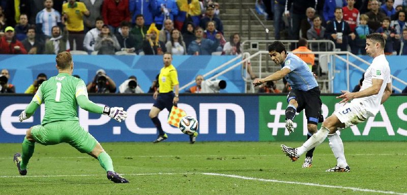 Luis Suarez scores his second goal of the game in Uruguay’s 2-1 victory over England in a Group D match Thursday in Sao Paulo.
