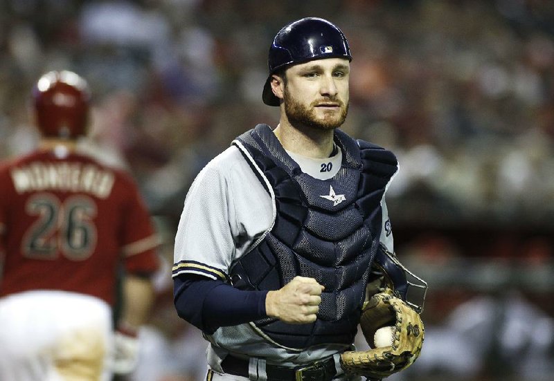 Milwaukee Brewers catcher Jonathan Lucroy, right, clutches his fist after Arizona Diamondbacks Miguel Montero (26) strikes out to end the inning during a baseball game on Wednesday, June 18, 2014, in Phoenix. The Diamondbacks defeated the Brewers 4-3. (AP Photo/Ralph Freso)