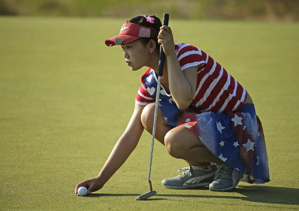 Lucy Li lines up a putt on the 13th hole during the first round of the U.S. Women's Open golf tournament in Pinehurst, N.C., Thursday, June 19, 2014. (AP Photo/Chuck Burton)