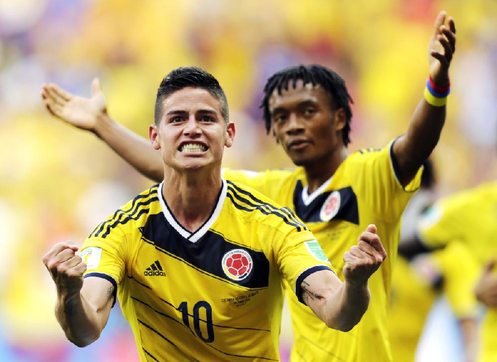 Colombia’s James Rodriguez (10) celebrates with teammate Colombia’s Juan Cuadrado after scoring his side’s first goal during the Group C World Cup soccer match between Colombia and Ivory Coast at the Estadio Nacional in Brasilia, Brazil, on Thursday.