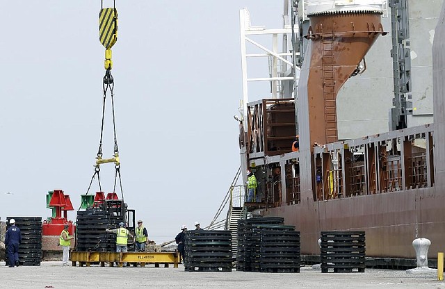 Dock workers at the Port of Cleveland load the freighter Fortunagracht, bound for Amsterdam, in April. U.S. exports dropped to $399.7 billion in the first quarter from $407.1 billion in the previous quarter, the Commerce Department reported Wednesday.