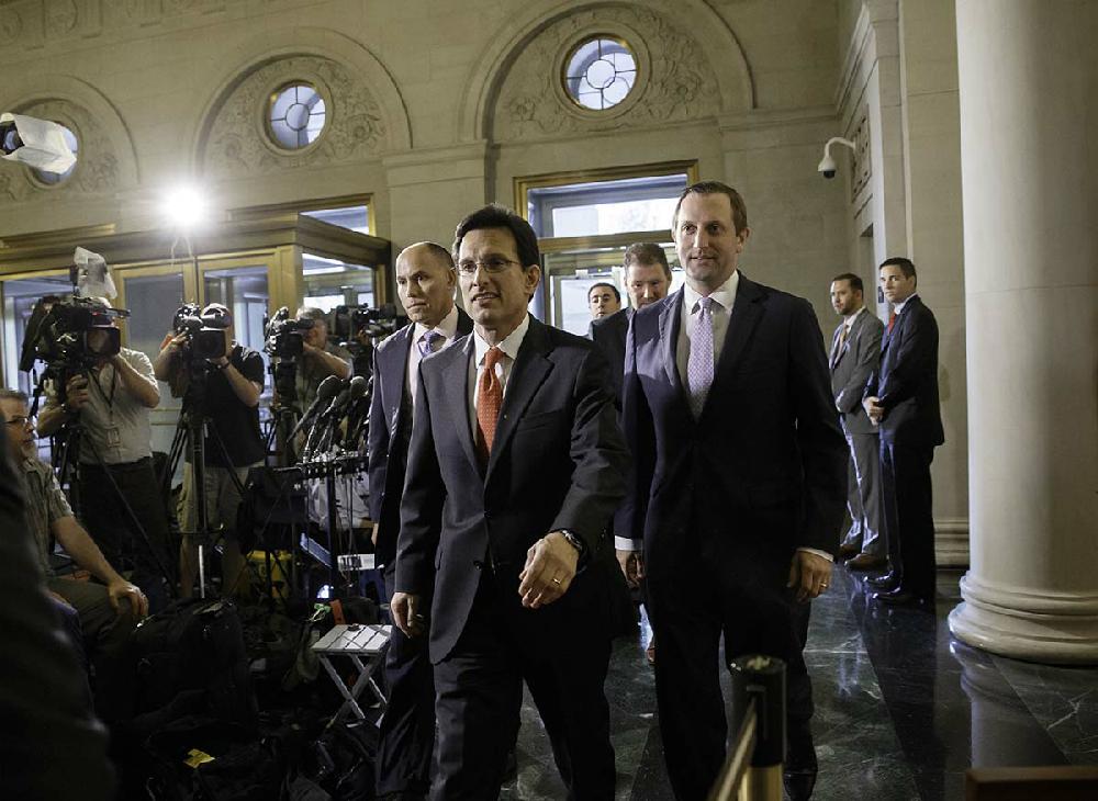 House Majority Leader Eric Cantor, R-Va., arrives as the House Republican Conference prepares to shuffle its leadership in the wake of Cantor's recent primary defeat in Virginia, on Capitol Hill in Washington, Thursday, June 19, 2014. Rep. Kevin McCarthy of California, currently the whip, was elected as new House majority leader. Cantor will step down at the end of July. (AP Photo/J. Scott Applewhite)