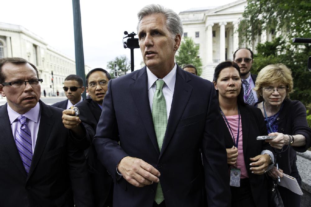 House Majority Whip Kevin McCarthy of Calif is pursued by reporters as he crosses Independence Ave. on Capitol Hill in Washington, Thursday, June 19, 2014, after being elected the new House majority leader by the Republican Conference, replacing Rep. Eric Cantor, R-Va., who was defeated in his primary earlier this month. Rep. Steve Scalise, R-La., is taking McCarthy's place as GOP whip. (AP Photo/J. Scott Applewhite)