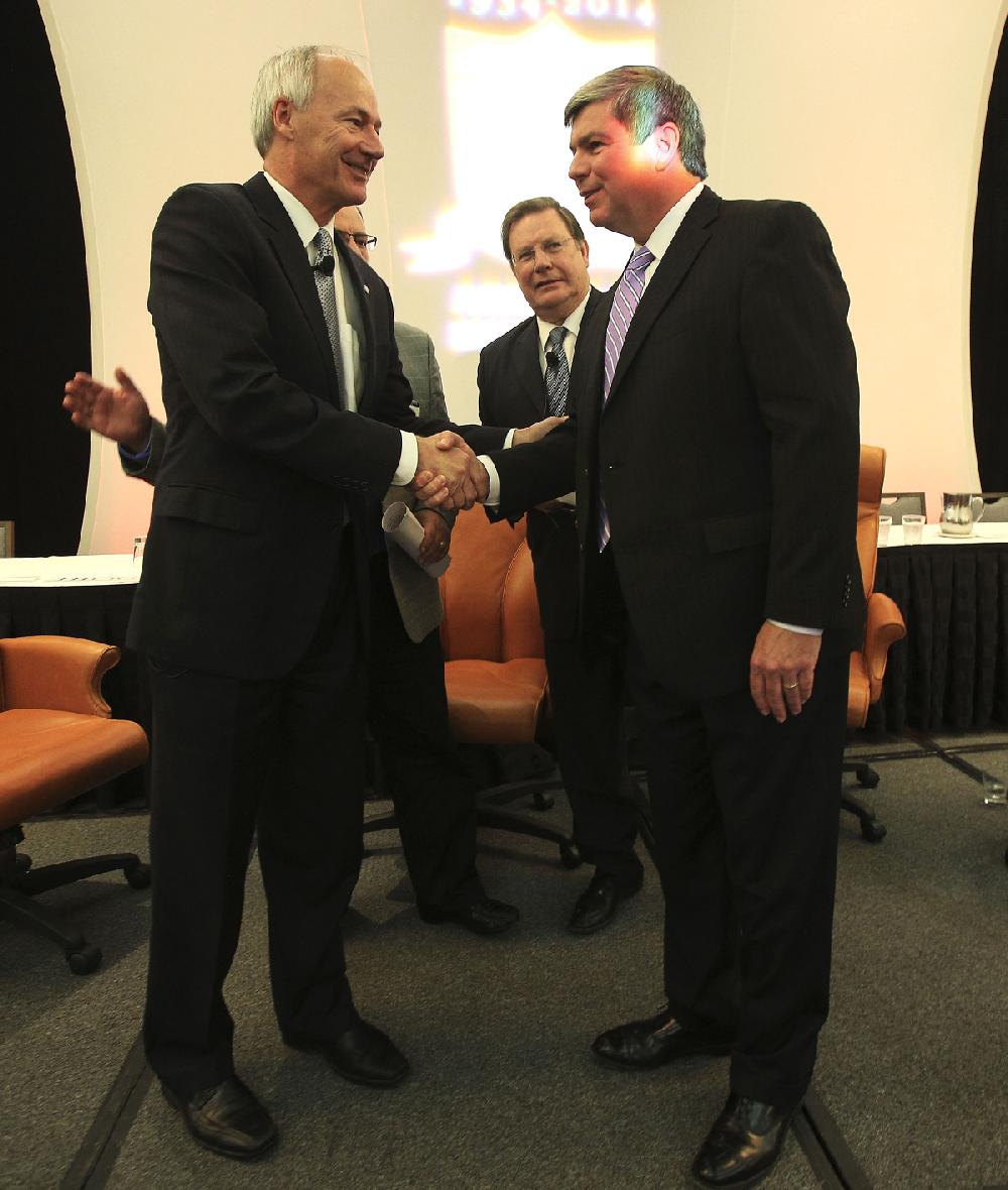 The two major party candidates for governor greet each other Thursday after speaking at the Arkansas Municipal League’s convention in Little Rock. Republican nominee Asa Hutchinson (left) and Democratic nominee Mike Ross were joined by Little Rock Mayor Mark Stodola (center).