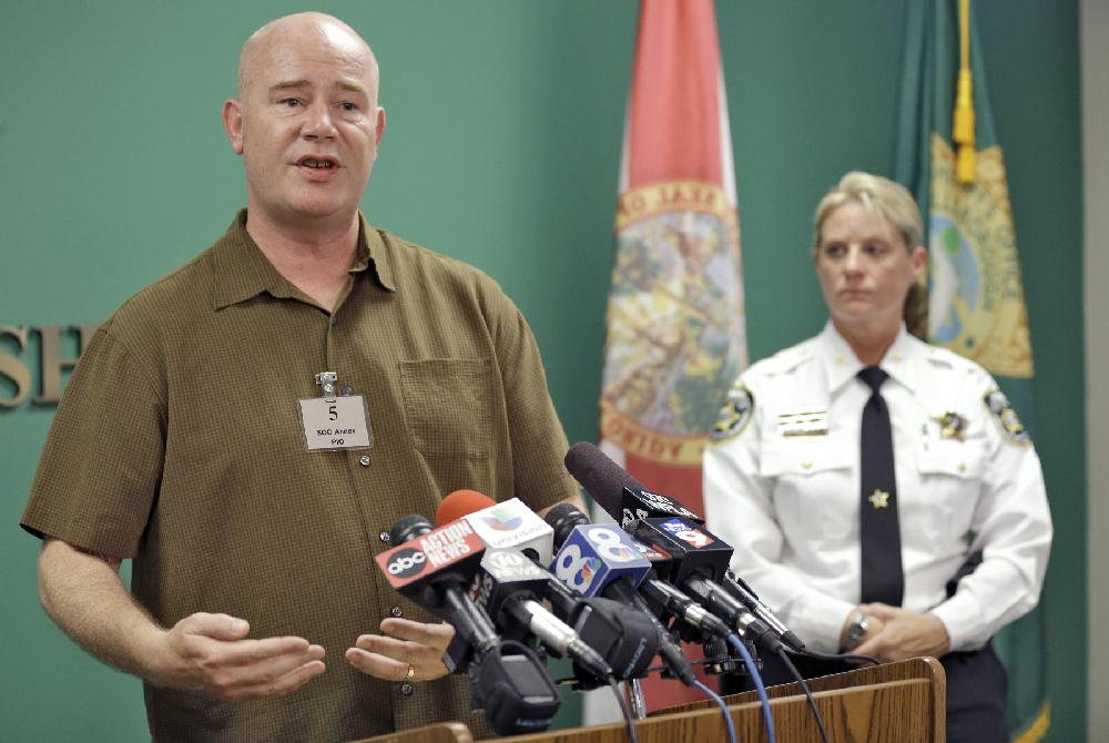Roger Lyon, father of a 16-year-old girl, left, gestures as he stands along with Hillsborough County Sheriff's Colonel Donna Lusczynski during a news conference Thursday, June 19, 2014, in Tampa, Fla. The Valrico, Fla., girl, who has been missing for a week, was found with a sex offender Thursday morning in Louisiana. She had been stabbed 10 times, according to the Hillsborough County Sheriff's Office. The HCSO said that the girl, who suffers from bipolar disorder, was in serious but stable condition at a Louisiana hospital. Sex offender Steven Myers, 41, is also hospitalized and is being treated for self-inflicted stab wounds. (AP Photo/Chris O'Meara)