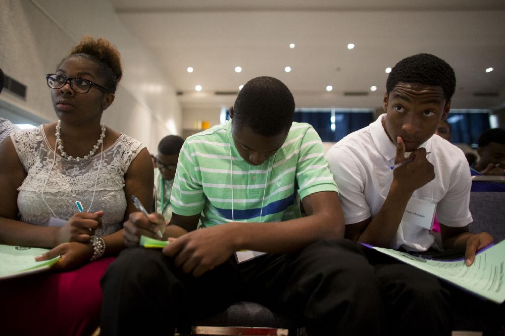 Arkansas Democrat-Gazette/MELISSA SUE GERRITS - 06/19/2014 -  Cierra Miller, Deshawn Matthews, and  Samuel Khabeer fill out time sheets during orientation for their Summer jobs with the City Of Little Rock June 19, 2014 at the Robinson Exhibit Center. The orientation is apart of the Summer Youth Employment Program which offers 750 young people between the ages of 16 and 24 seven weeks of employment plus a one-week training program to prepare them for the responsibilities and expectations of area employers.