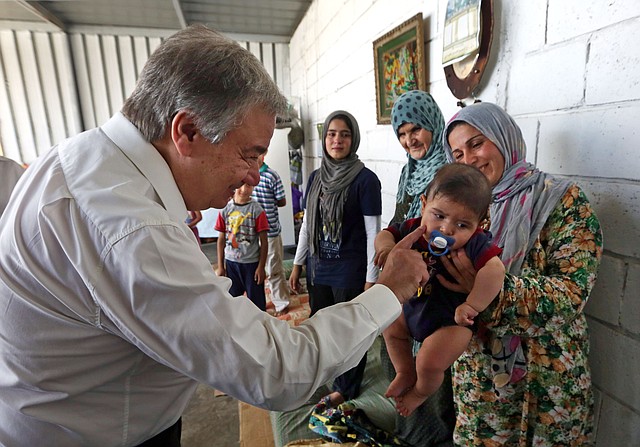 United Nations High Commissioner for Refugees (UNHCR) Antonio Guterres greets a Syrian child during his visit to Khaldeh, south of Beirut, Lebanon, Thursday, June 19, 2014. Guterres is visiting Lebanon where he will meet some Syrian refugees and discuss the situation with Lebanese officials. Lebanon, home to 4.5 million people, is struggling to cope with the presence of more than 1 million refugees in desperate need of housing, education and medical care. 