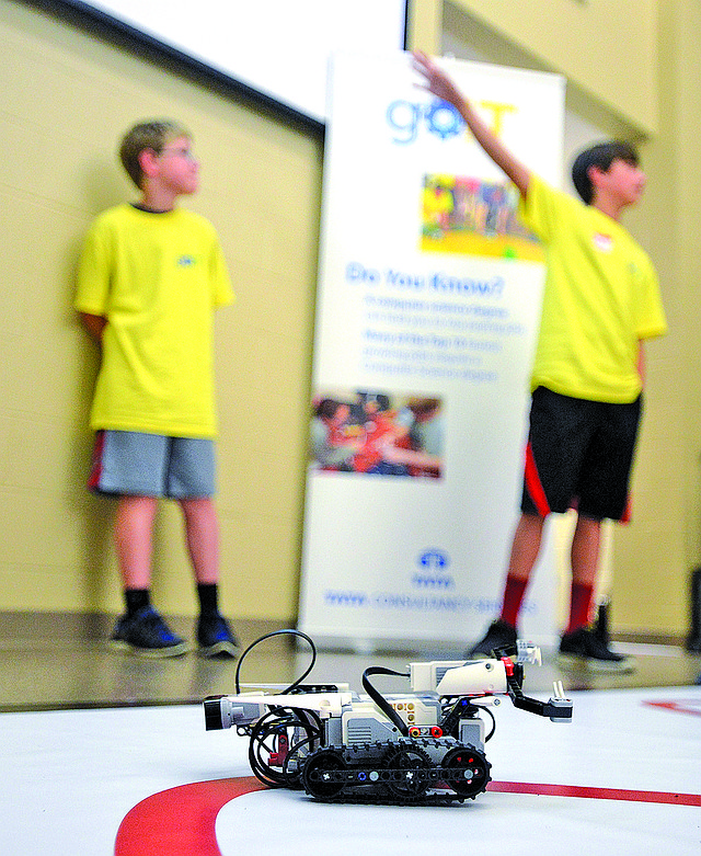 Carter Breeling and Brock McRae give a presentation Thursday about what they learned at the goIT camp, including how they programed a Lego robot at the TREC Gifted and Talented building in Bentonville. Students were participating in a three-day camp focusing on science, technology engineering and math to excited students about career prospects in those areas.