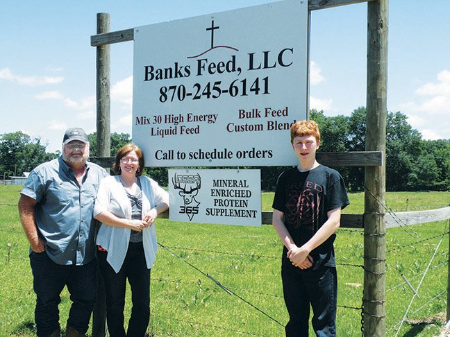 In addition to raising cattle, hay and timber, Geno, from left, Stephanie and Tyler Banks own and operate Banks Feed LLC, offering custom cattle feed, liquid cattle feed and a mineral-enriched protein supplement for deer.