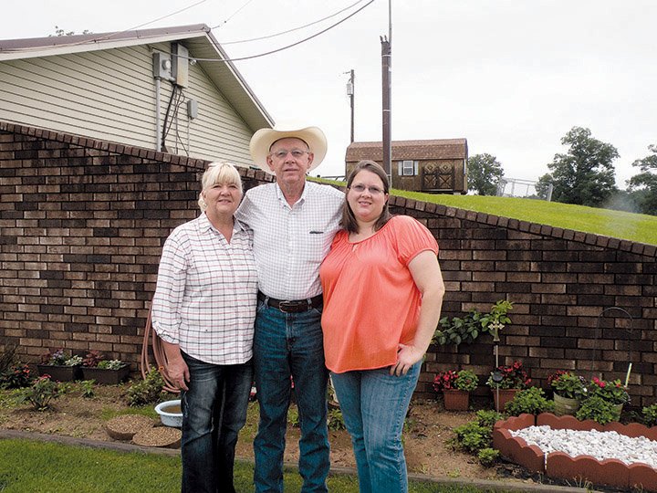 The Stan Garner family of Danville has been named 2014 Yell County Farm Family of the Year. Standing in front of their “earth-sheltered” home are, from left, Betty and Stan Garner and their daughter, Crystal. They farm 160 acres, serving as contract grazers for a cow/calf operation. 