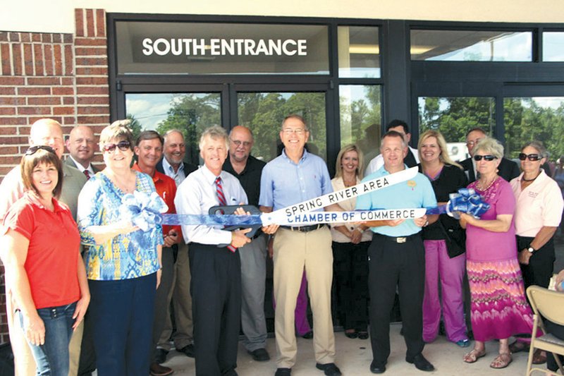 Gary Bebow, CEO of White River Health System (center with scissors), prepares to cut the ribbon during the recent WRMC Medical Complex Emergency Room open house. The Satellite Emergency Room, the first in the state of Arkansas, will officially transition to a 24/7 care facility on Monday.