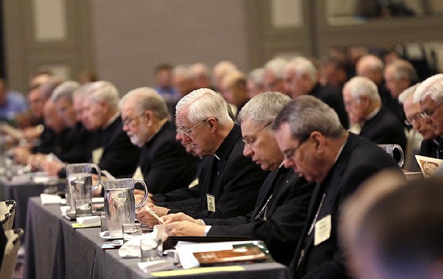 Participants pray at the start of the morning general session at the United States Conference of Catholic Bishops in New Orleans, Wednesday, June 11, 2014. The nation’s Roman Catholic bishops are holding their mid-year meeting as they wrestle with the new agenda set by Pope Francis to make compassion a priority over hot-button issues such as abortion. 