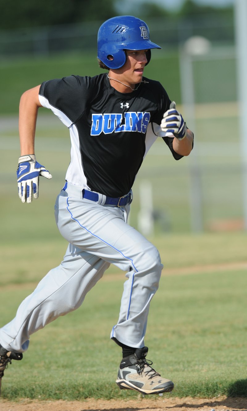 STAFF PHOTO ANDY SHUPE Grae Kessinger heads to first base during play Wednesday at the Tyson Sports Complex in Springdale.