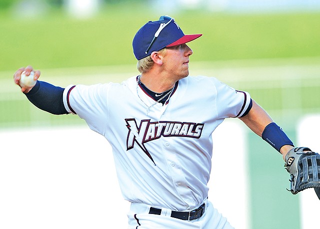 STAFF PHOTO ANDY SHUPE Hunter Dozier, Northwest Arkansas third baseman, makes a throw to first Friday against Tulsa at Arvest Ballpark in Springdale.