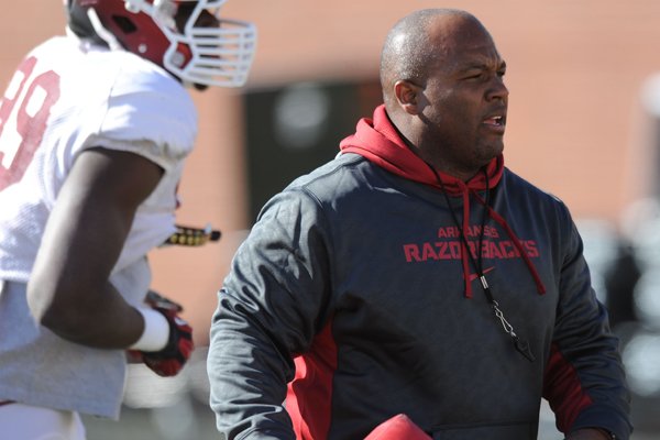 Arkansas defensive backs coach Clay Jennings directs his players during practice Thursday, March 20, 2014, at the UA practice field in Fayetteville.