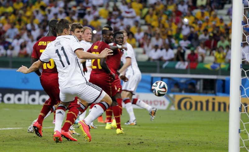 Germany’s Miroslav Klose (11) scores his team’s second goal against Ghana in Fortaleza, Brazil, on Saturday.The goal allowed Germany to get a 2-2 tie. 