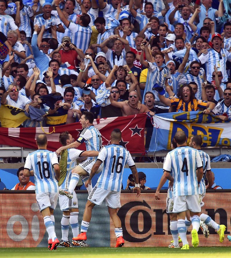 Argentina’s Lionel Messi (third from left) celebrates with teammates after scoring a goal during Saturday’s World Cup Group F match against Iran at the Mineirao Stadium in Belo Horizonte, Brazil. Argentina won 1-0 and secured a berth in the second round.