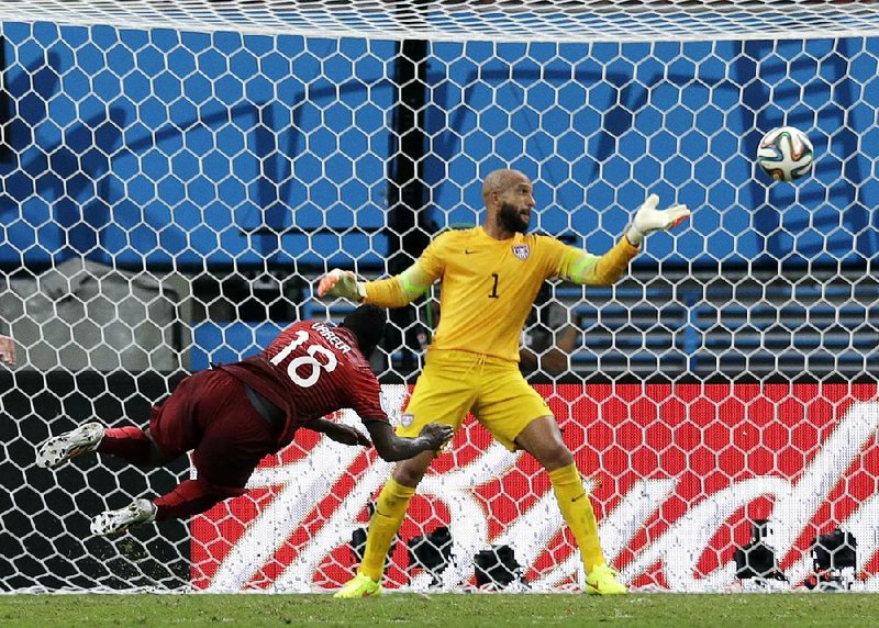 Portugal's Silvestre Varela heads the ball past United States' goalkeeper Tim Howard to score his side's second goal and tie the game 2-2 during the group G World Cup soccer match between the USA and Portugal at the Arena da Amazonia in Manaus, Brazil, Sunday, June 22, 2014. (AP Photo/Martin Mejia)