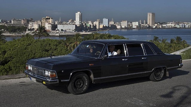 In this June 18, 2014 photo, taxi driver Moises Suarez navigates the Soviet-made limousine that he rents from the government in Havana, Cuba. Today the fleet of limos that were once part of Fidel Castro's fleet have been decommissioned and repurposed as Havana taxi cabs, at the service of tourists who want a little slice of history to go with their ride across town. (AP Photo/Franklin Reyes)