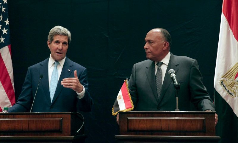U.S. Secretary of State John Kerry, left, speaks during a joint news conference with Egyptian Foreign Minister Sameh Shoukry following his meeting with Egyptian President Abdel-Fattah el-Sissi, Sunday, June 22, 2014, in Cairo, Egypt. (AP Photo/Maya Alleruzzo)