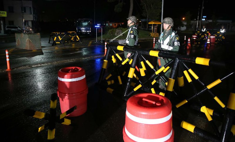 South Korean soldiers man a temporary checkpoint early today near North Korea after a sergeant opened fire, killing several fellow soldiers.