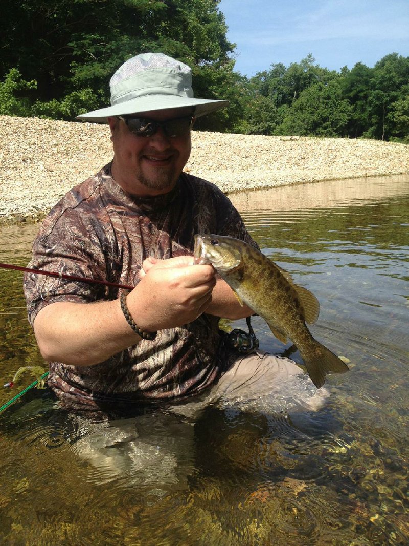 Alan Thomas of Russellville shows off one of many smallmouth bass caught Wednesday on Sylamore Creek.
