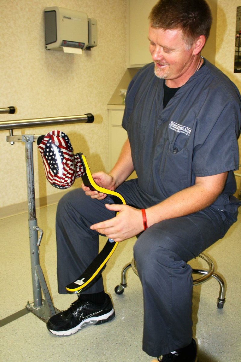 Arkansas Democrat Gazette/CYD KING - 06/20/2014 - Francois Van Der Watt of Fort Smith holds a prosthetics blade. Van Der Watt developed runner Oscar Pistorius' prosthetics.
 


