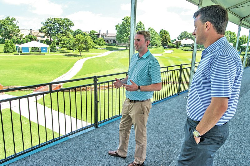 STAFF PHOTO ANTHONY REYES Harry Hardy, left, tournament director, and Andy Bush, executive tournament director, talk Wednesday in club house seating at Pinnacle Country Club in Rogers. The pair both work for Octagon that manages the LPGA event.