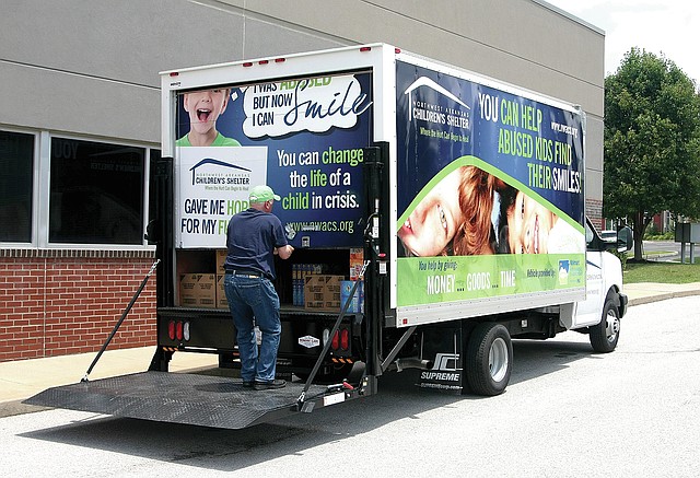  STAFF PHOTO SAMANTHA BAKER &#8226; @NWASAMANTHA Steve Schotta, executive director for the Northwest Arkansas Children&#8217;s Shelter, closes the door of the new truck the shelter received from the Walmart NW Arkansas Championship golf tournament Friday at Mondelez International&#8217;s office in Rogers. The larger truck allows the shelter to more easily pick up donations.