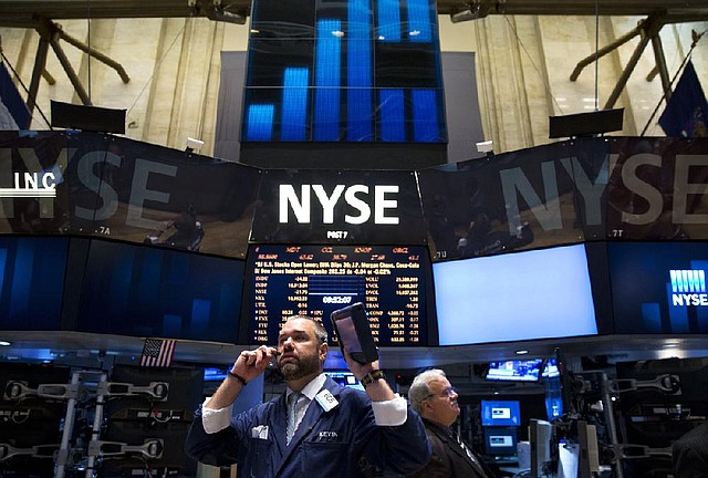 Traders work Tuesday on the •oor of the New York Stock Exchange.