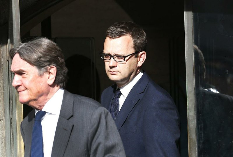 Andy Coulson (background), former News of the World editor, leaves the Central Criminal Court in London on Tuesday after being convicted for a role in phone hacking.