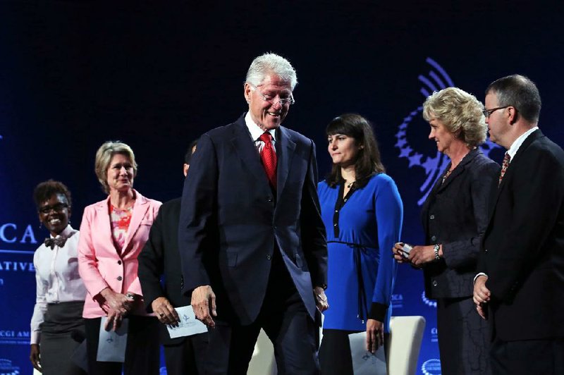 Former President Bill Clinton smiles during a session of the annual gathering of the Clinton Global Initiative America at the Sheraton Downtown in Denver on Tuesday. 