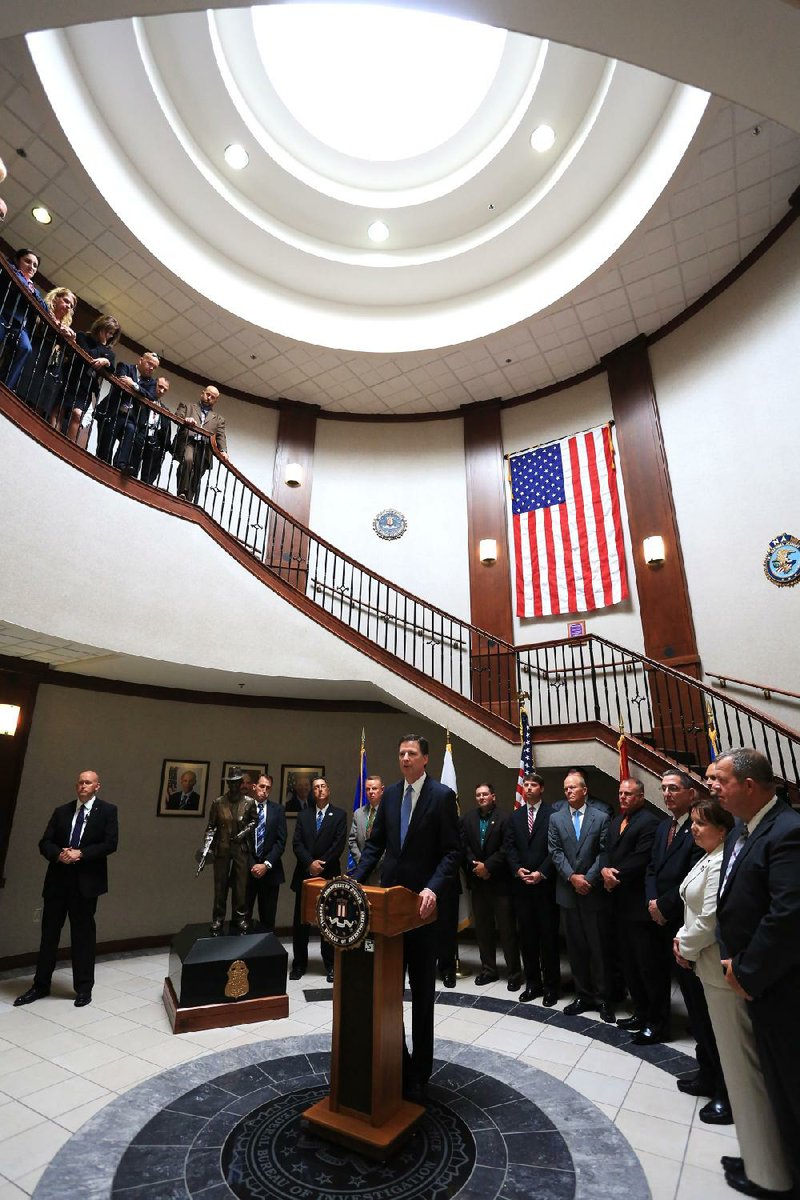 FBI Director James Comey, surrounded by law enforcement officers from around the state and agents at the Little Rock offices of the Federal Bureau of Investigation, talks Tuesday about terrorism and the threat it poses to the United States.