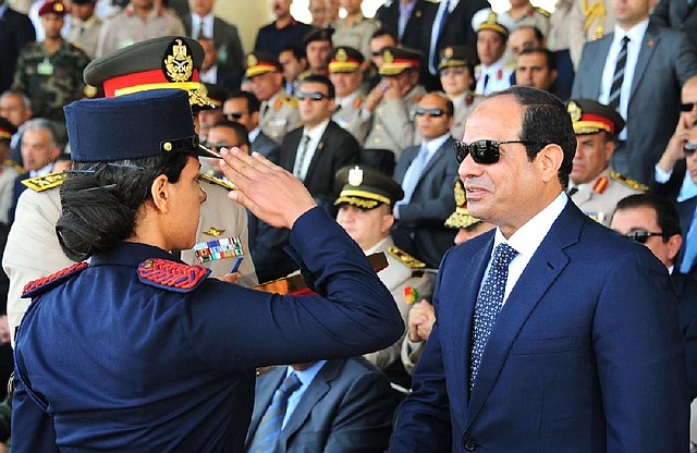 Egyptian President Abdel-Fattah el-Sissi is saluted by a female cadet at a military graduation in Cairo on Tuesday. El-Sissi said Tuesday that he will not interfere in court rulings. 