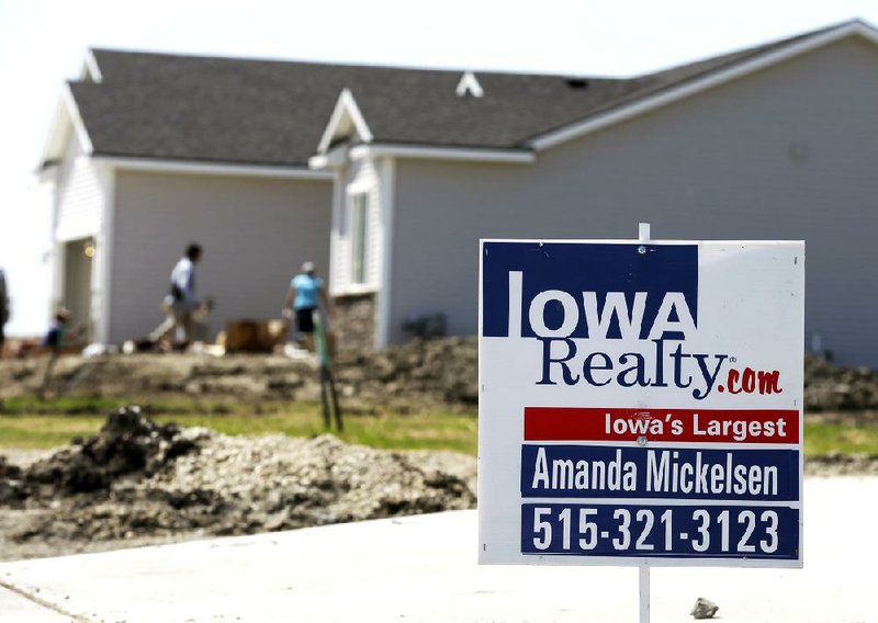 A sign marks a home for sale in West Des Moines, Iowa, in May. Sales of new homes last month exceeded economists’ forecasts as the industry rebounded from a winter lull.