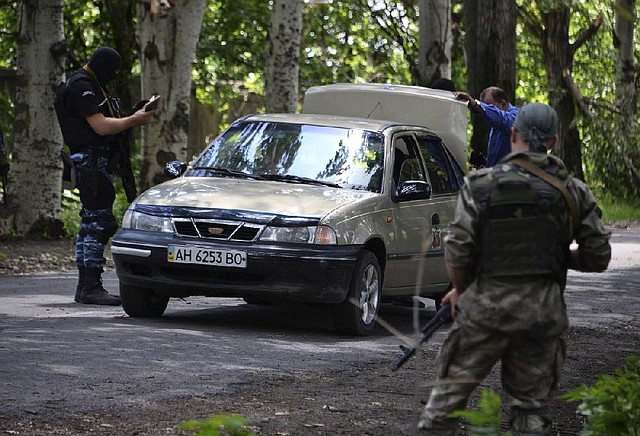 Ukrainian soldiers check a car at a checkpoint near Slovyansk, Ukraine, on Tuesday.