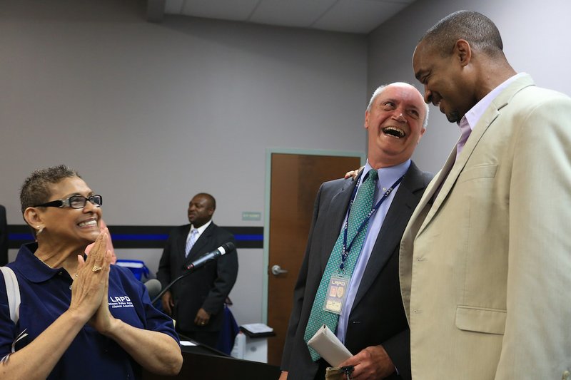 Arkansas Democrat-Gazette/RICK MCFARLAND --06/23/14--   Little Rock Police Chief Stuart Thomas (center) is congratulated by Ken Richardson, City Director for Ward 2, at a retirement ceremony Monday for Thomas at the Little Rock Police Department Training Division. Thomas' last day is June 27. He joined the department in 1978 and became chief in 2005.
