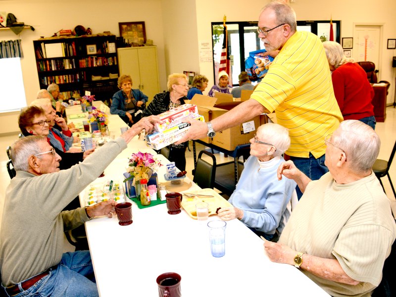 Jeff Della Rosa/Herald-Leader Richard Grubb, driver for the senior center, hands out snacks that are donated to the center.