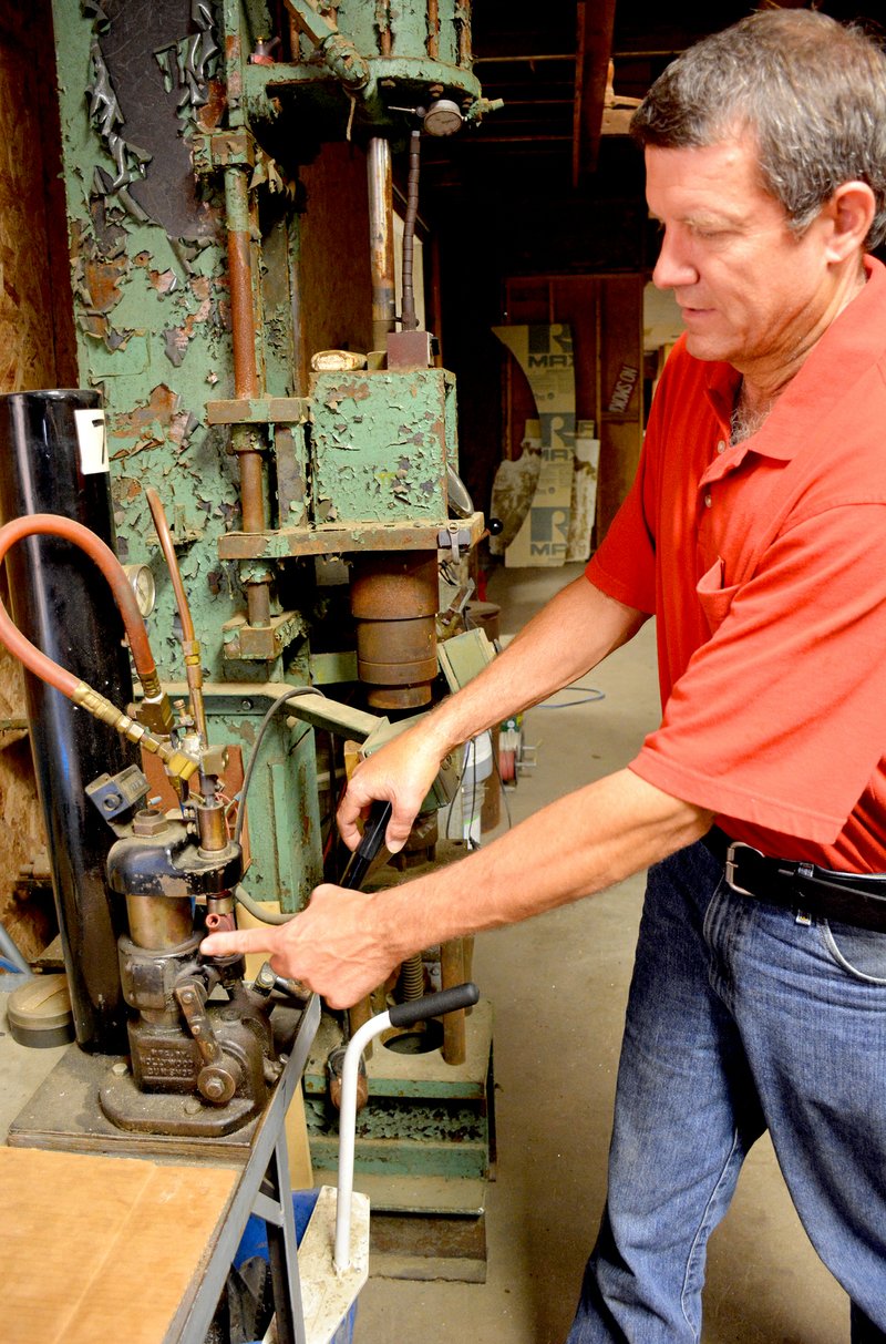 Jeff Della Rosa/Herald-Leader Dan Orcutt, owner of RediGun, shows a tool that&#8217;s used in the assembly of a RediGun.