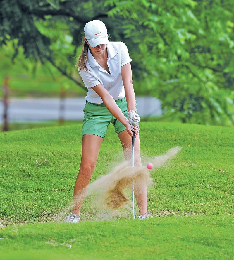 Staff Photo Michael Woods &#8226; @NWAMICHAELW Madde Weston chips out of a sand trap Thursday while competing in a youth golf tournament at Prairie Creek Country Club in Rogers. Weston is one of many youth volunteers for the LPGA golf tournament this week at Pinnacle Country Club in Rogers.