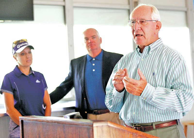 STAFF PHOTO JASON IVESTER Golfer Natalie Gulbis, from left, and tournament chairman Jay Allen listen as Mark Simmons with the Northwest Arkansas Council speaks Tuesday during a check presentation at the Walmart NW Arkansas Championship presented by P&amp;G at Pinnacle Country Club in Rogers. Walmart presented the council with $450,000 to foster economic development, diversity and inclusion.