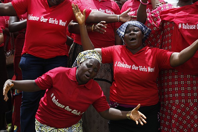 In this file photo taken on Tuesday, May 27, 2014, Women attend a prayer meeting calling on the government to rescue the kidnapped girls of the government secondary school in Chibok, in Abuja, Nigeria. Extremists have abducted 91 more people, including toddlers as young as 3, in weekend attacks on villages in Nigeria, witnesses said Tuesday, June 24, 2014, providing fresh evidence of the military's failure to curb an Islamic uprising and the governments inability to provide security. The victims included 60 girls and women, some of whom were married, and 31 boys, witnesses said. A local official confirmed the abductions, but security forces denied them. Nigeria's government and military have been internationally embarrassed by their slow response to the abductions of more than 200 schoolgirls who were kidnapped April 15 and remain captive.
