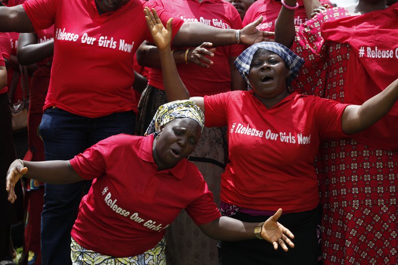 In this file photo taken on Tuesday, May 27, 2014, Women attend a prayer meeting calling on the government to rescue the kidnapped girls of the government secondary school in Chibok, in Abuja, Nigeria. Extremists have abducted 91 more people, including toddlers as young as 3, in weekend attacks on villages in Nigeria, witnesses said Tuesday, June 24, 2014, providing fresh evidence of the military's failure to curb an Islamic uprising and the governments inability to provide security. The victims included 60 girls and women, some of whom were married, and 31 boys, witnesses said. A local official confirmed the abductions, but security forces denied them. Nigeria's government and military have been internationally embarrassed by their slow response to the abductions of more than 200 schoolgirls who were kidnapped April 15 and remain captive.