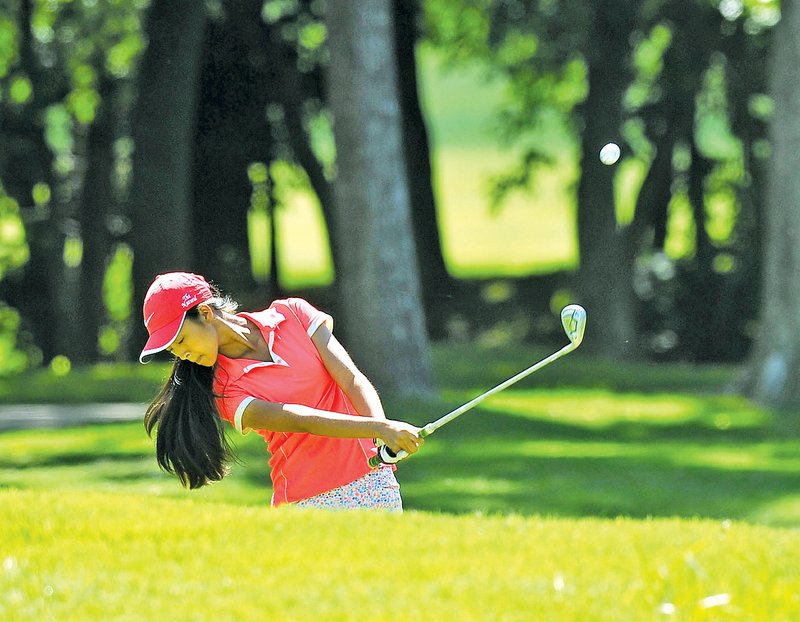  Staff Photo Michael Woods w @NWAMICHAELW Elizabeth Moon of Forrest City chips off the 10th fairway Tuesday morning during the final round of the ASGA Stroke Play tournament at Shadow Valley Country Club in Rogers.