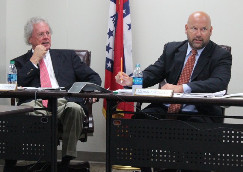 Arkansas Scholarship Lottery Director Bishop Woosley, right, speaks while lottery commissioner John C. Campbell III looks on during a meeting Wednesday.