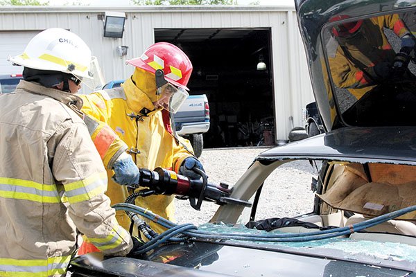 Ethan Simpson, 16, who will be a junior at Fountain Lake High School this fall, suited up and used the Jaws of Life and a saw in a mock exercise to extradite a person from a wrecked vehicle on June 19 during the Summer MASH program at CHI St. Vincent Hot Springs hospital. Simpson said he plans to become a cardiologist.
