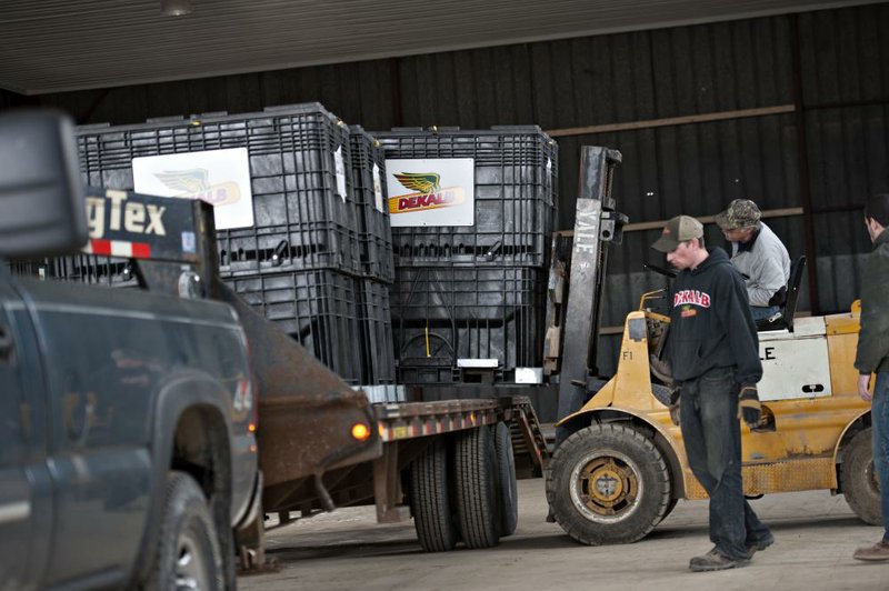 Monsanto Co.’s DeKalb brand seed corn is unloaded at a farm outside Walnut, Ill., in April. The company Wednesday reported a quarterly profit of $858 million, or $1.62 per share.